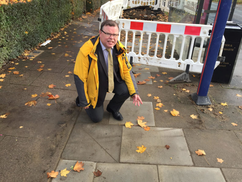 Andrew Waller pointing at a pavement in York