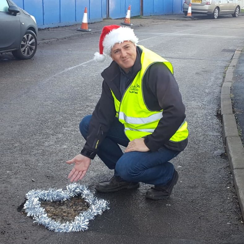 Adrian England and a pothole with tinsel