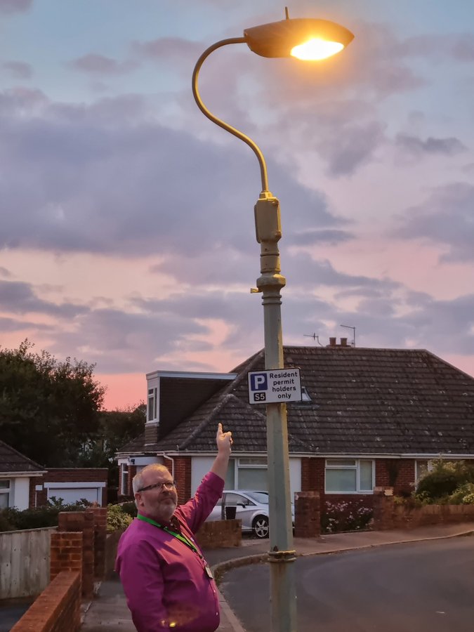 Cllr Kevin Mitchell pointing at a lamp post